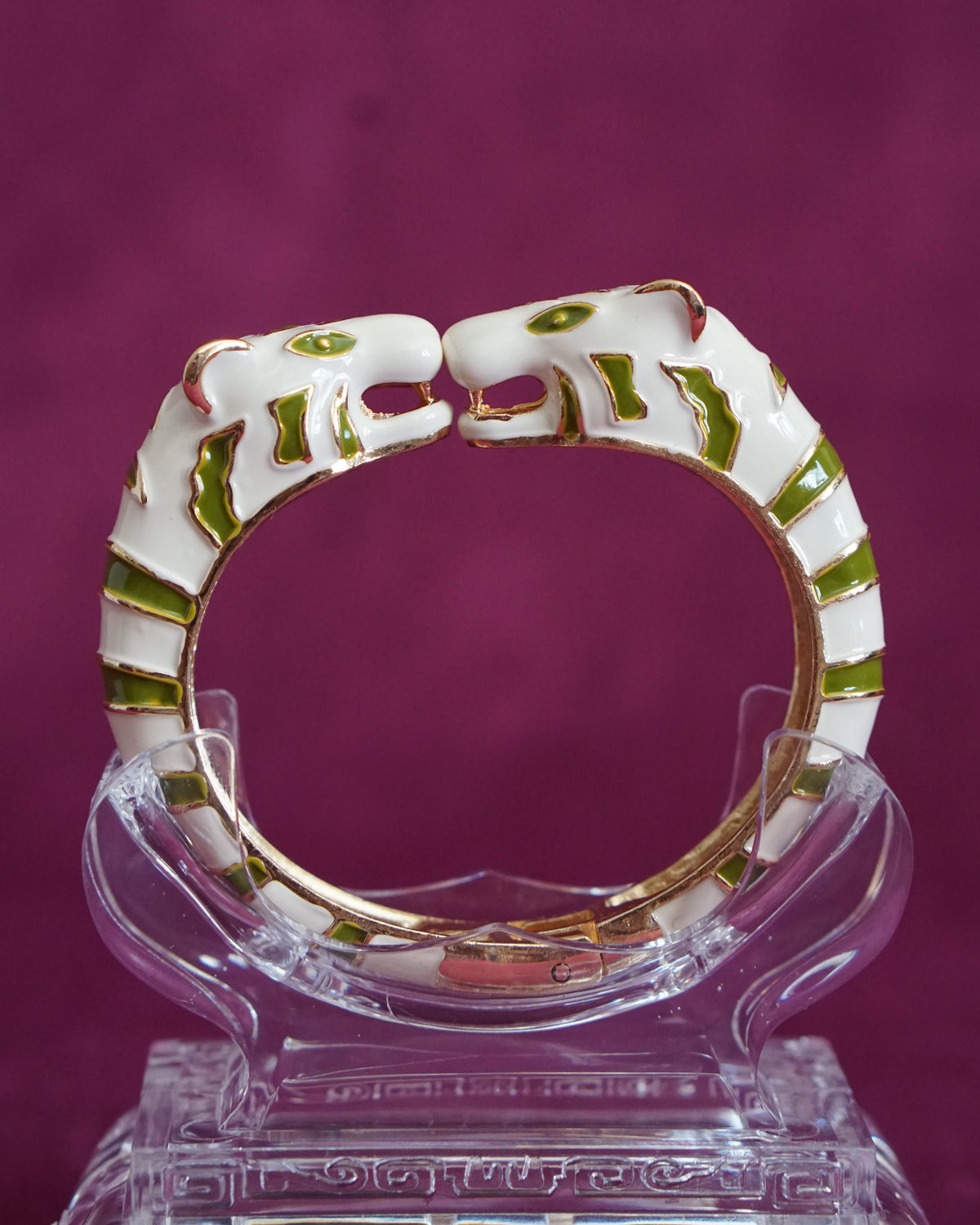 Hinged bangle with two cream tigers meeting face to face, striped in olive green