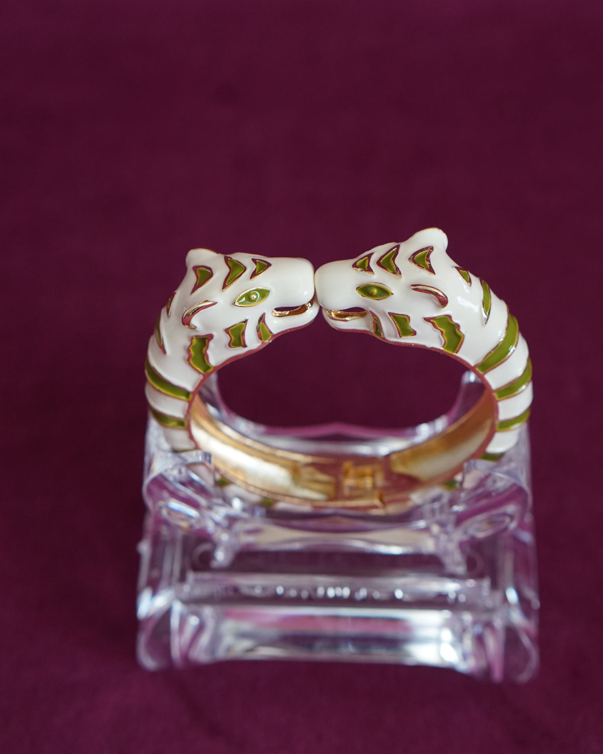 Hinged bangle with two cream tigers meeting face to face, striped in olive green