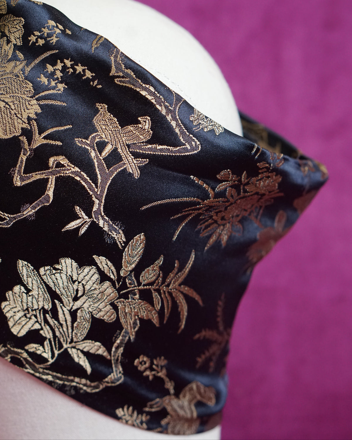 Handmade wired turban headband in black and gold satin brocade woven with perched birds
