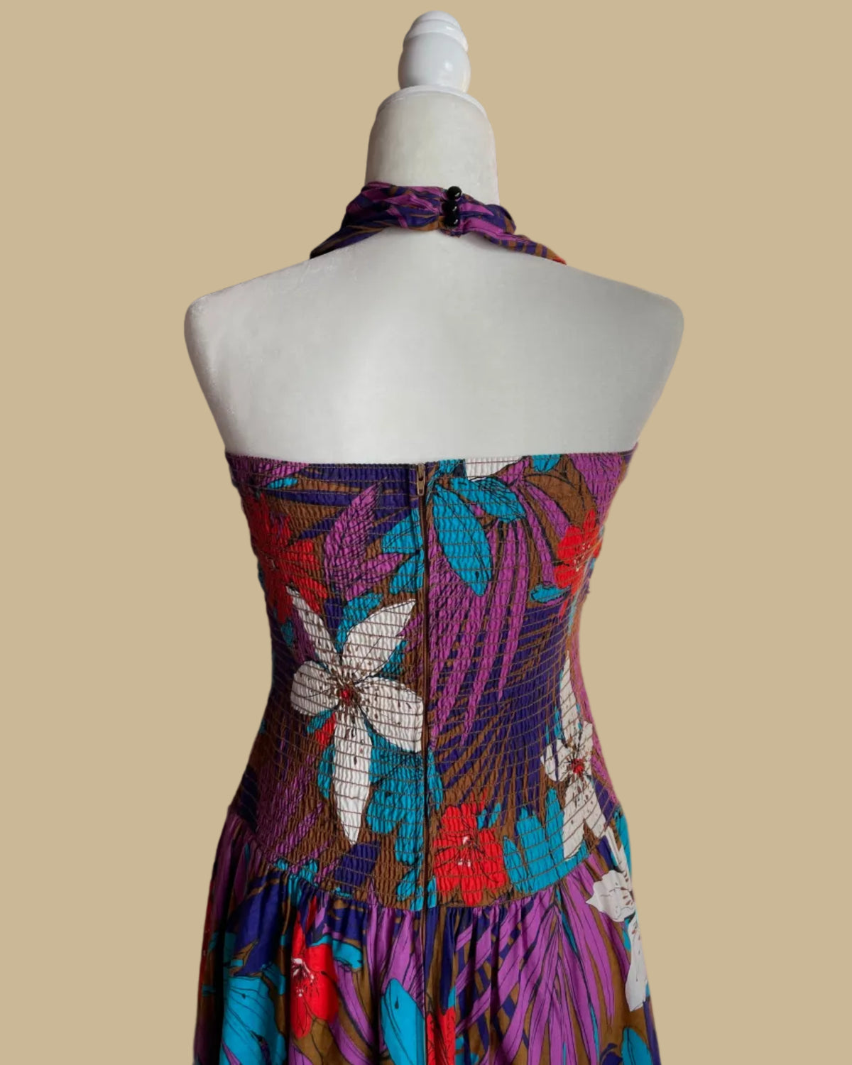 Close-up of the smocked bodice on the tropical floral halter dress