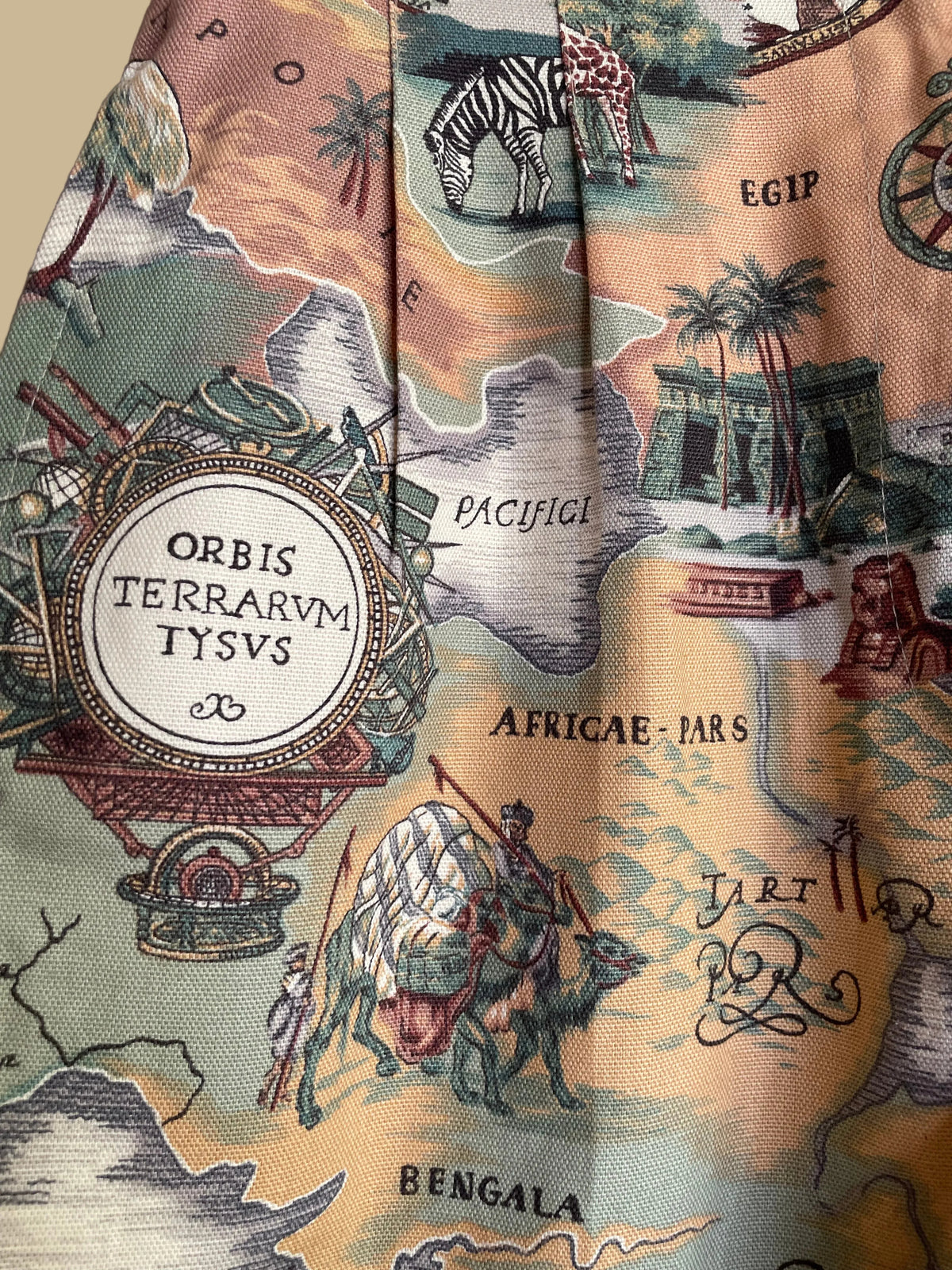 Side view of the vintage map cartography print high-waisted shorts on a hanger