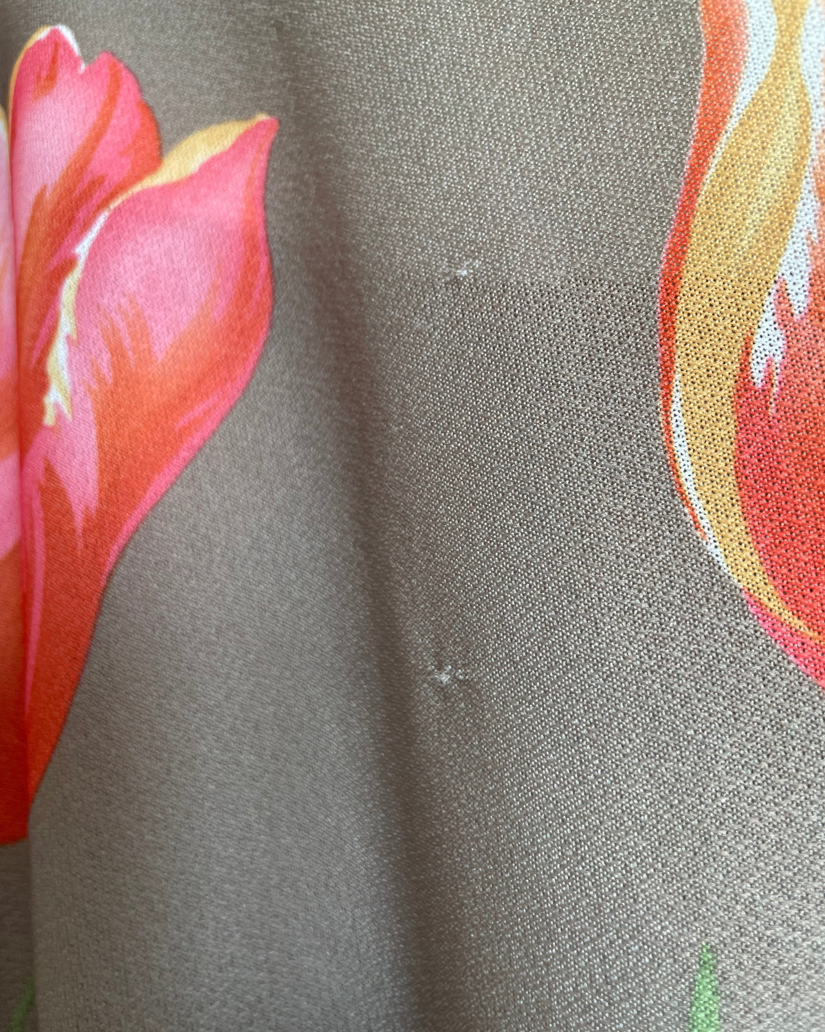 A vintage Herman Marcus tulip print dress in a taupe and cream colorblock with dolman sleeves, shown against a kraft background