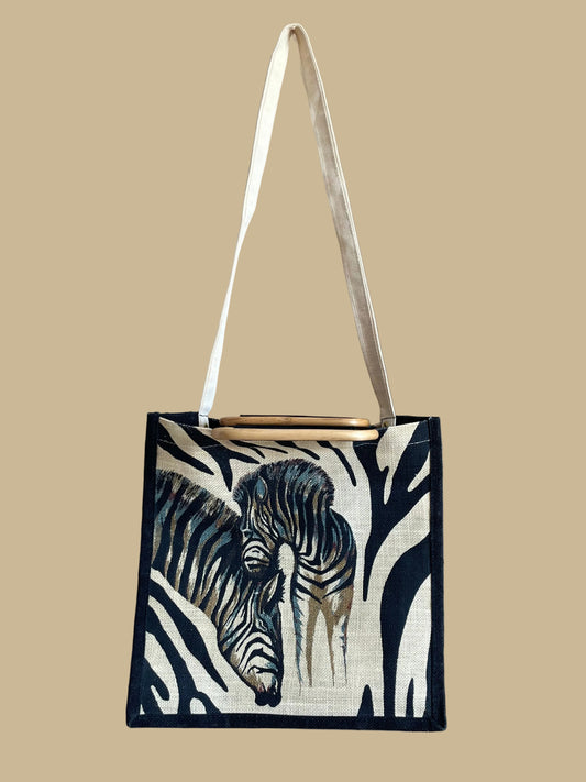 A vintage handmade zebra print canvas tote bag with bamboo handles and a fabric shoulder strap, shown against a kraft background