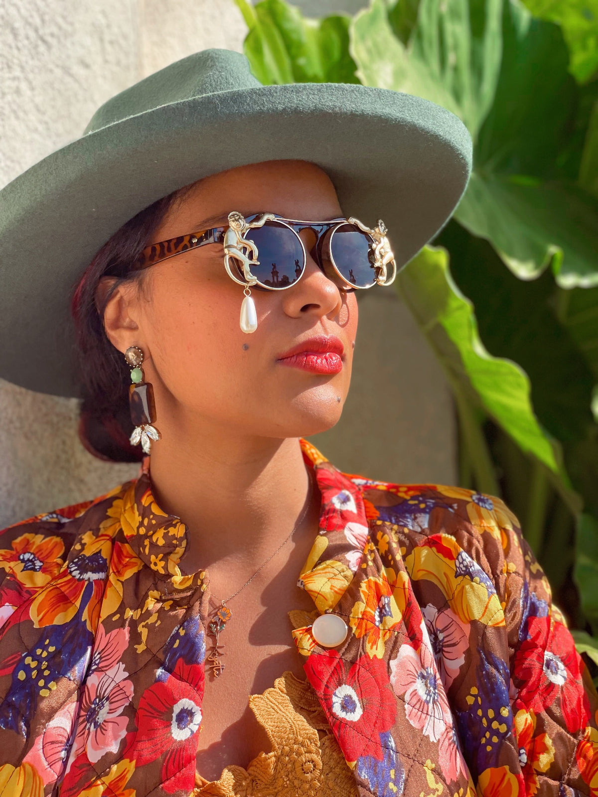 Side view of the tortoise shell flip-up sunglasses showing the pearl drop detail