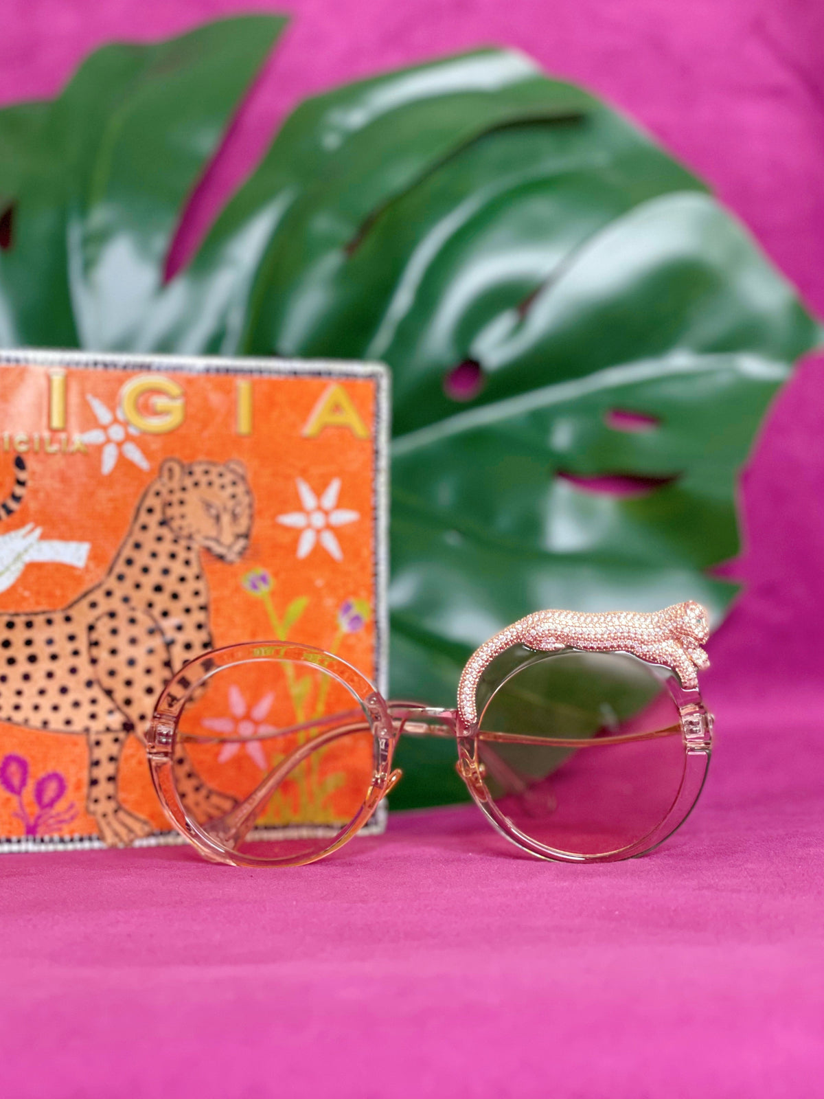Side view of the Fierce Feline Rosé Champagne sunglasses showing the leopard figure and lens