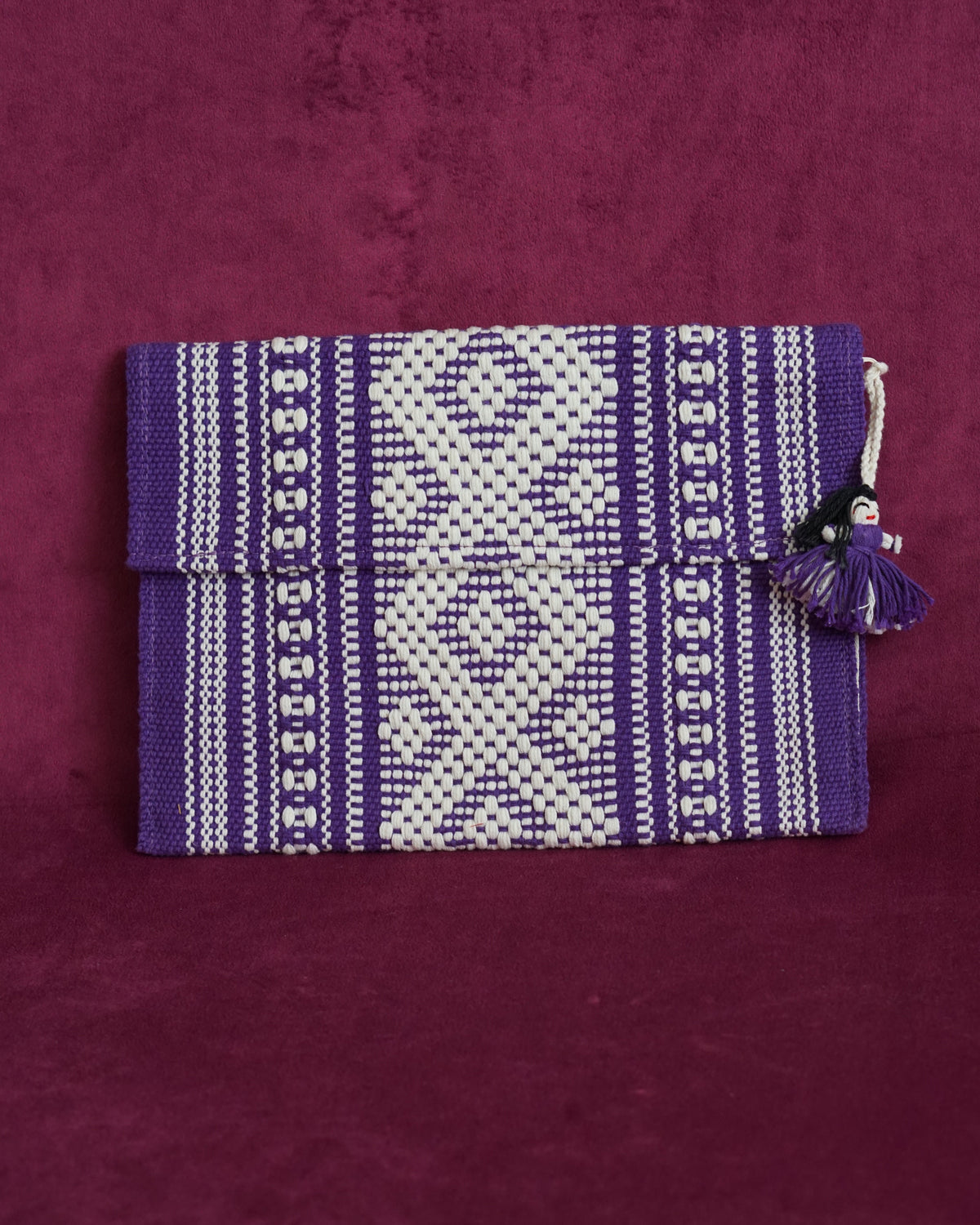 Handwoven cotton clutch in purple and cream with a raised diamond and dot pattern, sourced from Mexico City