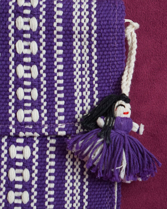 Handwoven cotton clutch in purple and cream with a raised diamond and dot pattern, sourced from Mexico City