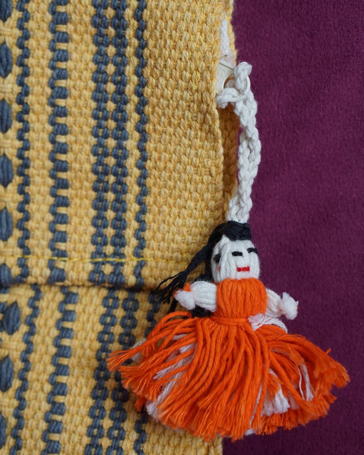 Handwoven cotton clutch in marigold and slate gray with a raised diamond and dot pattern, sourced from Mexico City