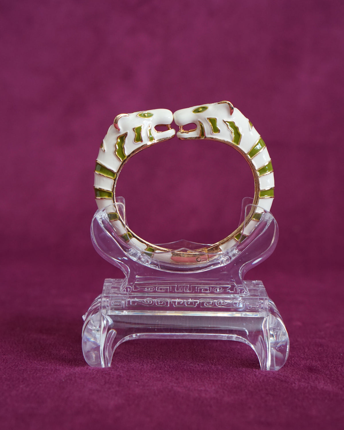 Hinged bangle with two cream tigers meeting face to face, striped in olive green