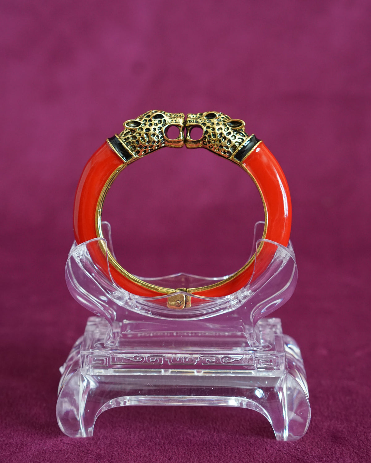 Glossy red enamel hinged bangle capped with two antiqued gold-tone leopard heads