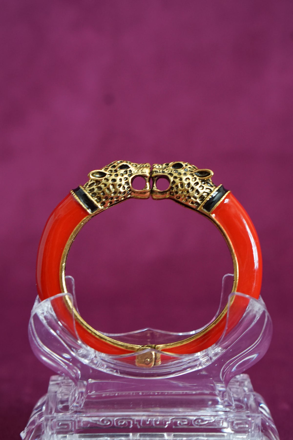 Glossy red enamel hinged bangle capped with two antiqued gold-tone leopard heads