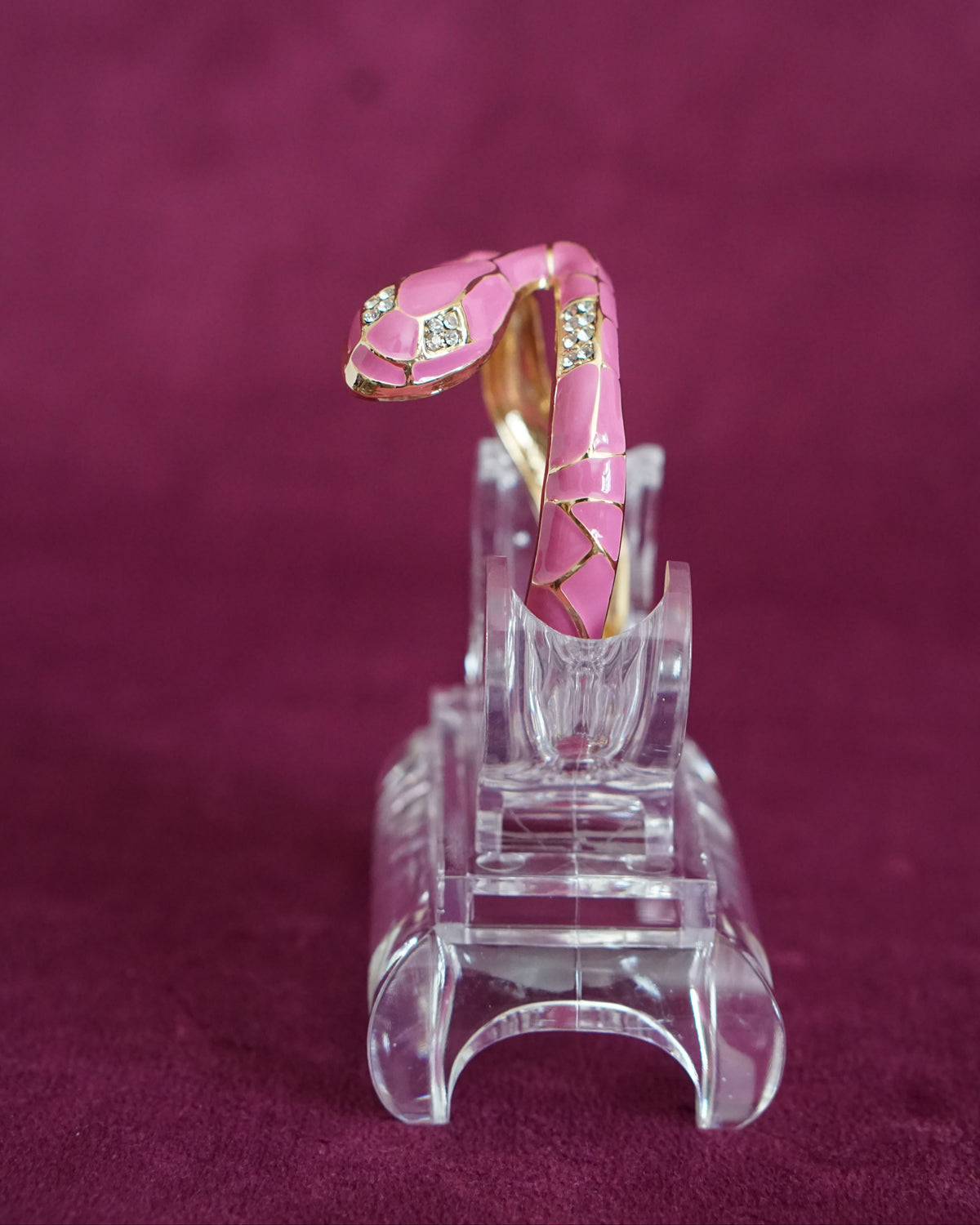 Hinged bangle shaped like a snake winding around the wrist, in orchid pink enamel scales