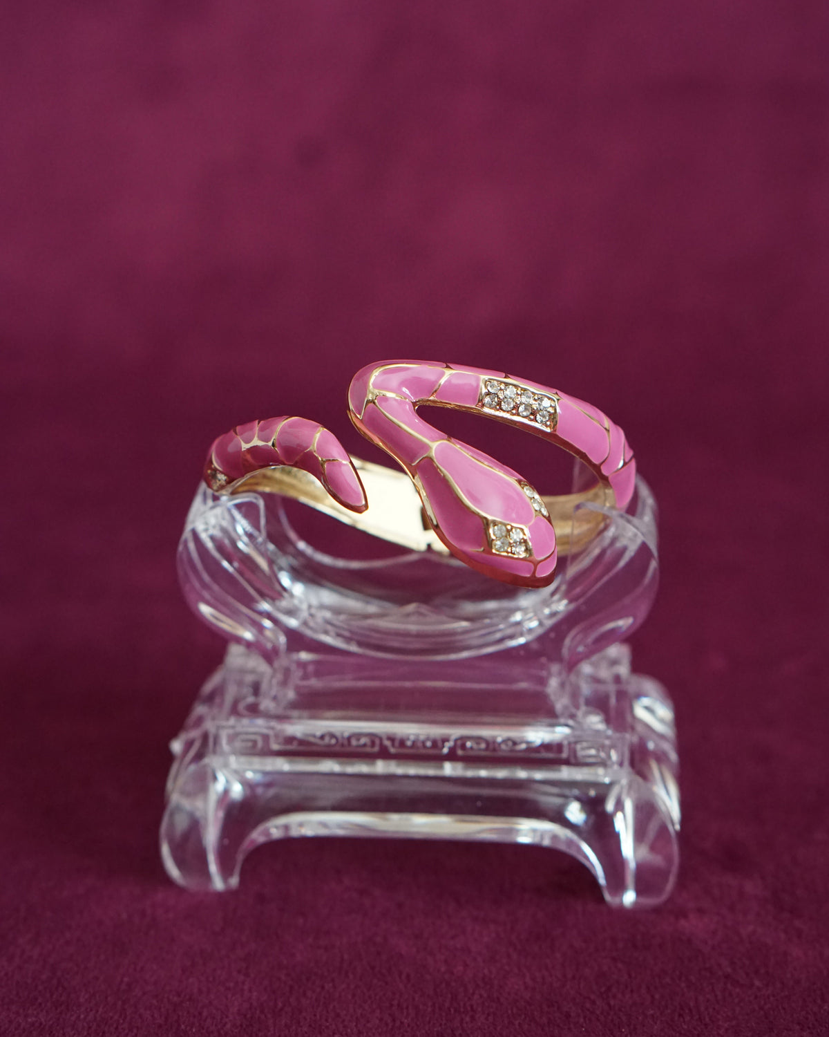 Hinged bangle shaped like a snake winding around the wrist, in orchid pink enamel scales