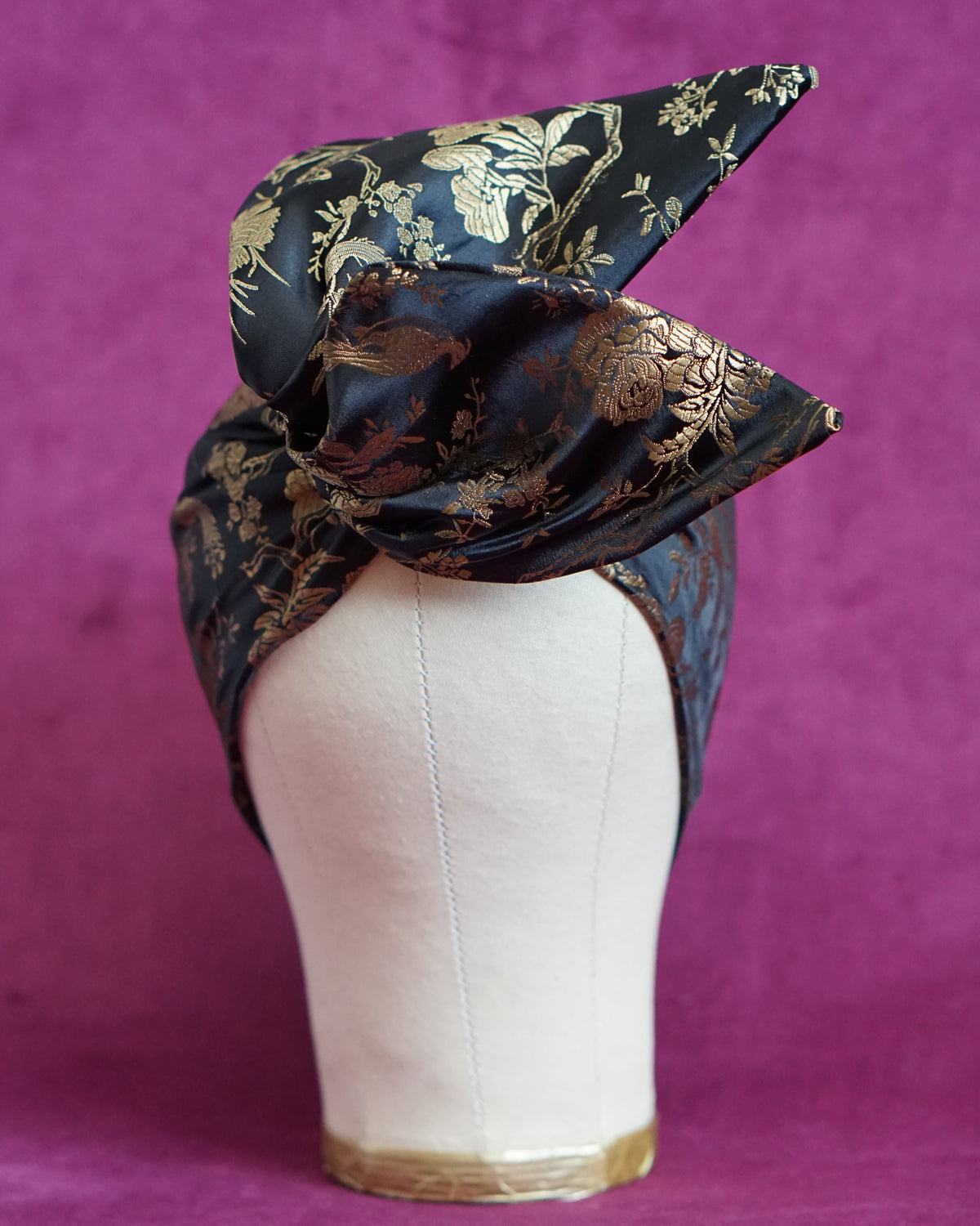Handmade wired turban headband in black and gold satin brocade woven with perched birds