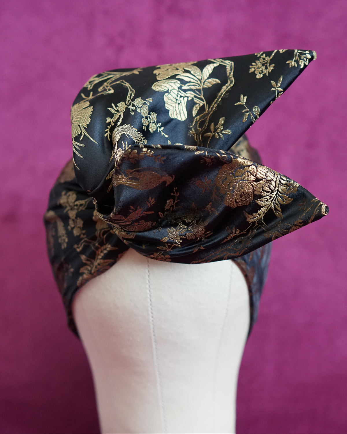Handmade wired turban headband in black and gold satin brocade woven with perched birds