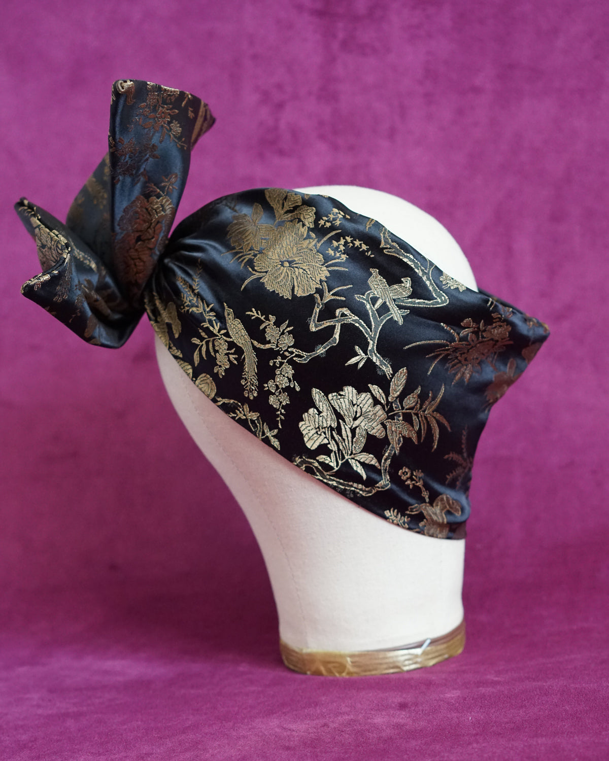Handmade wired turban headband in black and gold satin brocade woven with perched birds