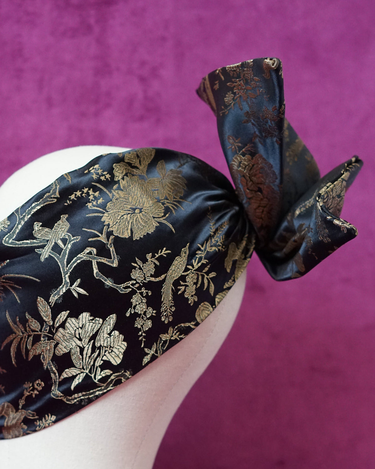 Handmade wired turban headband in black and gold satin brocade woven with perched birds