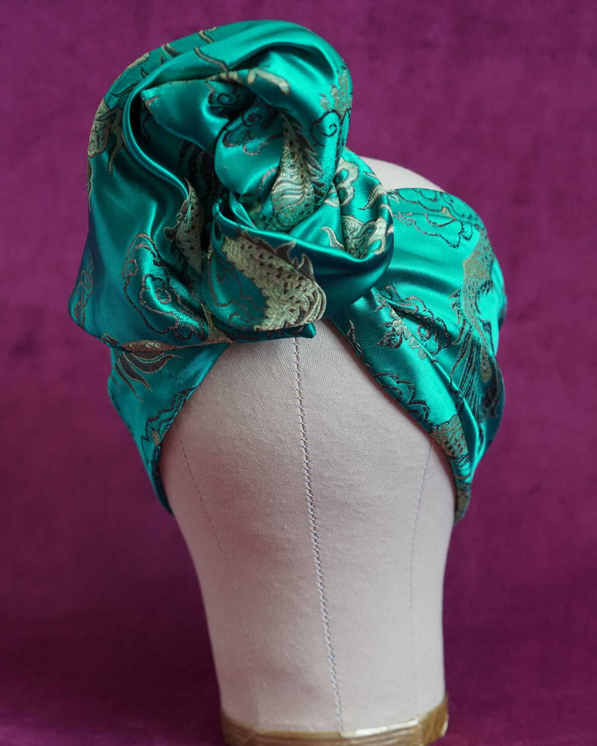 Handmade wired turban headband in jewel-toned teal satin brocade woven with gold dragons