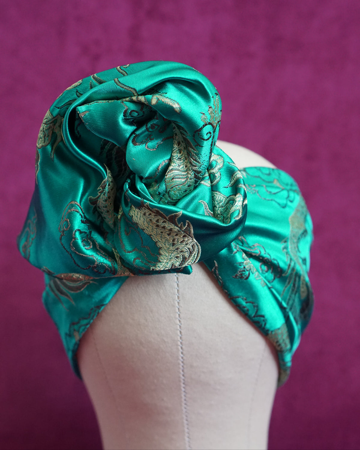 Handmade wired turban headband in jewel-toned teal satin brocade woven with gold dragons