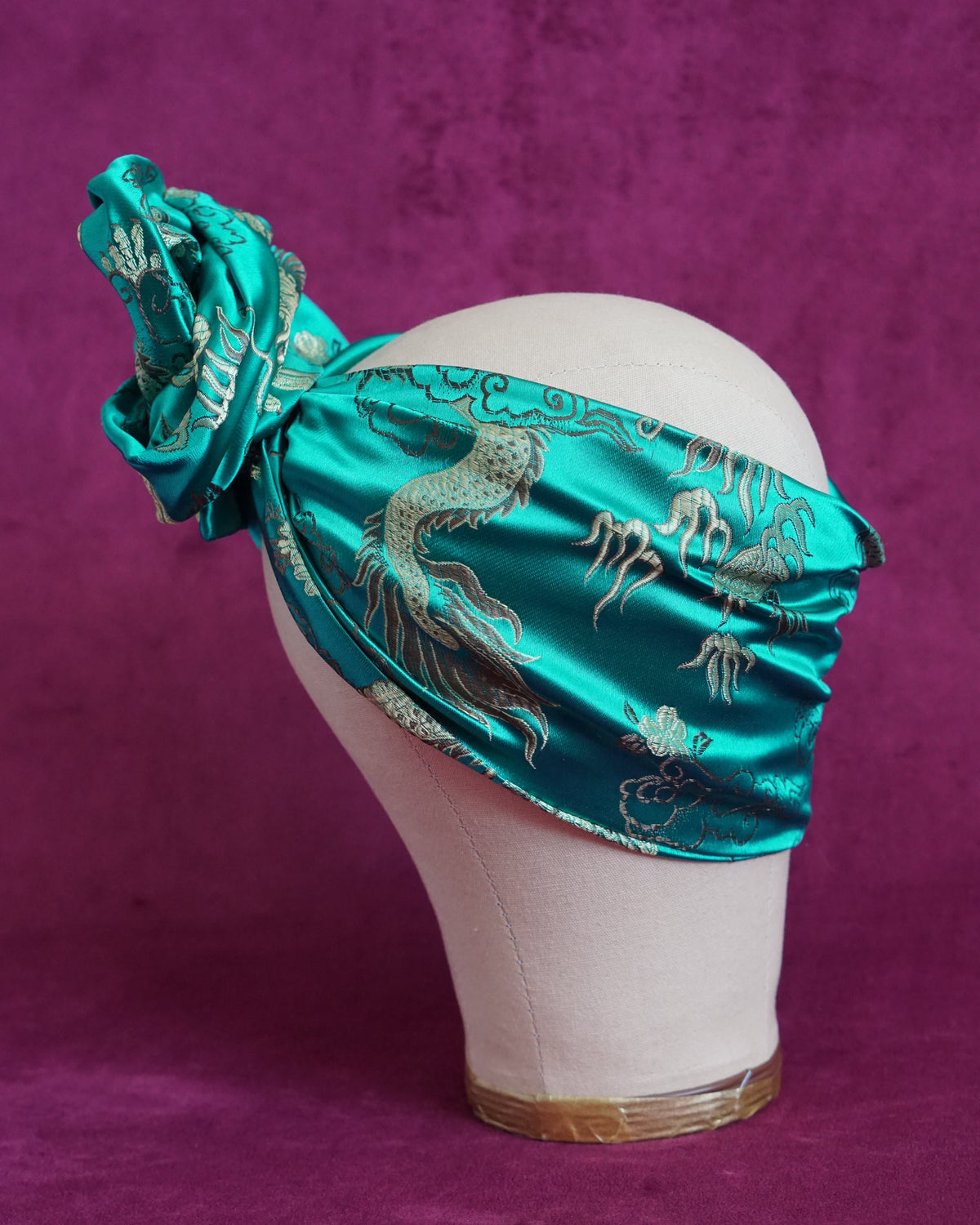 Handmade wired turban headband in jewel-toned teal satin brocade woven with gold dragons