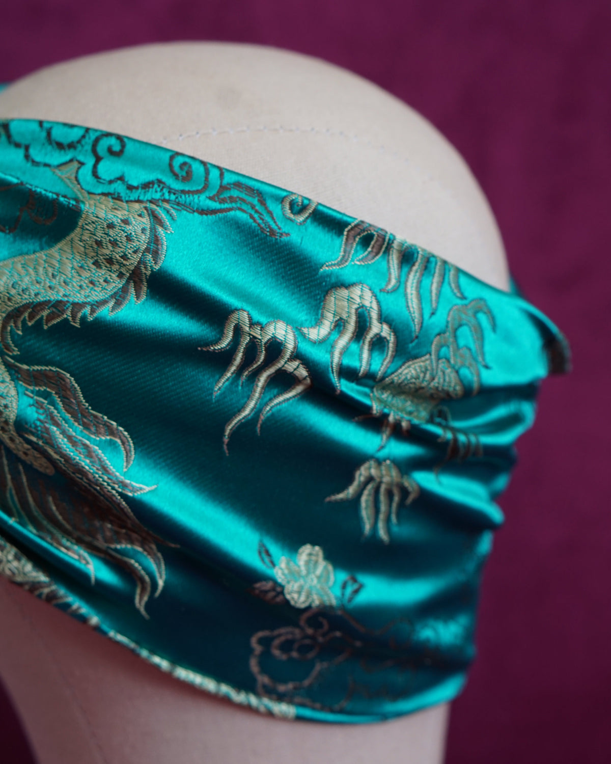 Handmade wired turban headband in jewel-toned teal satin brocade woven with gold dragons