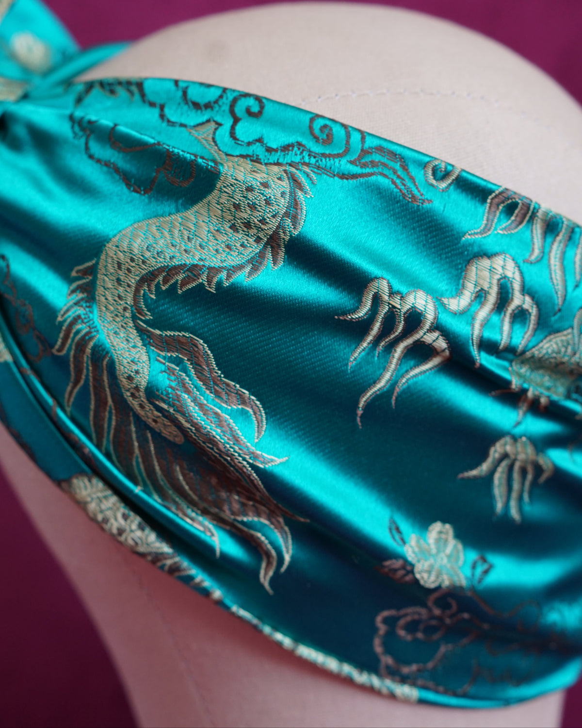 Handmade wired turban headband in jewel-toned teal satin brocade woven with gold dragons