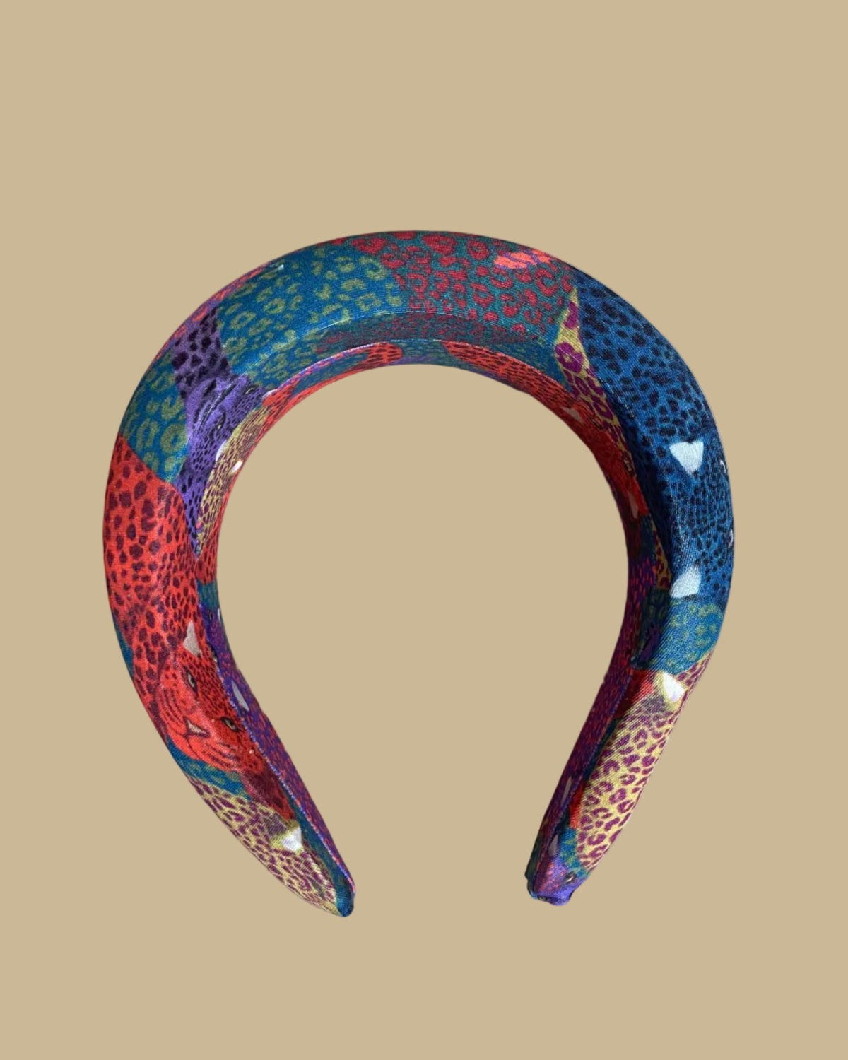 Wide padded Farm Rio headband in a patchwork of jewel-toned leopards in purple, red, teal, and olive
