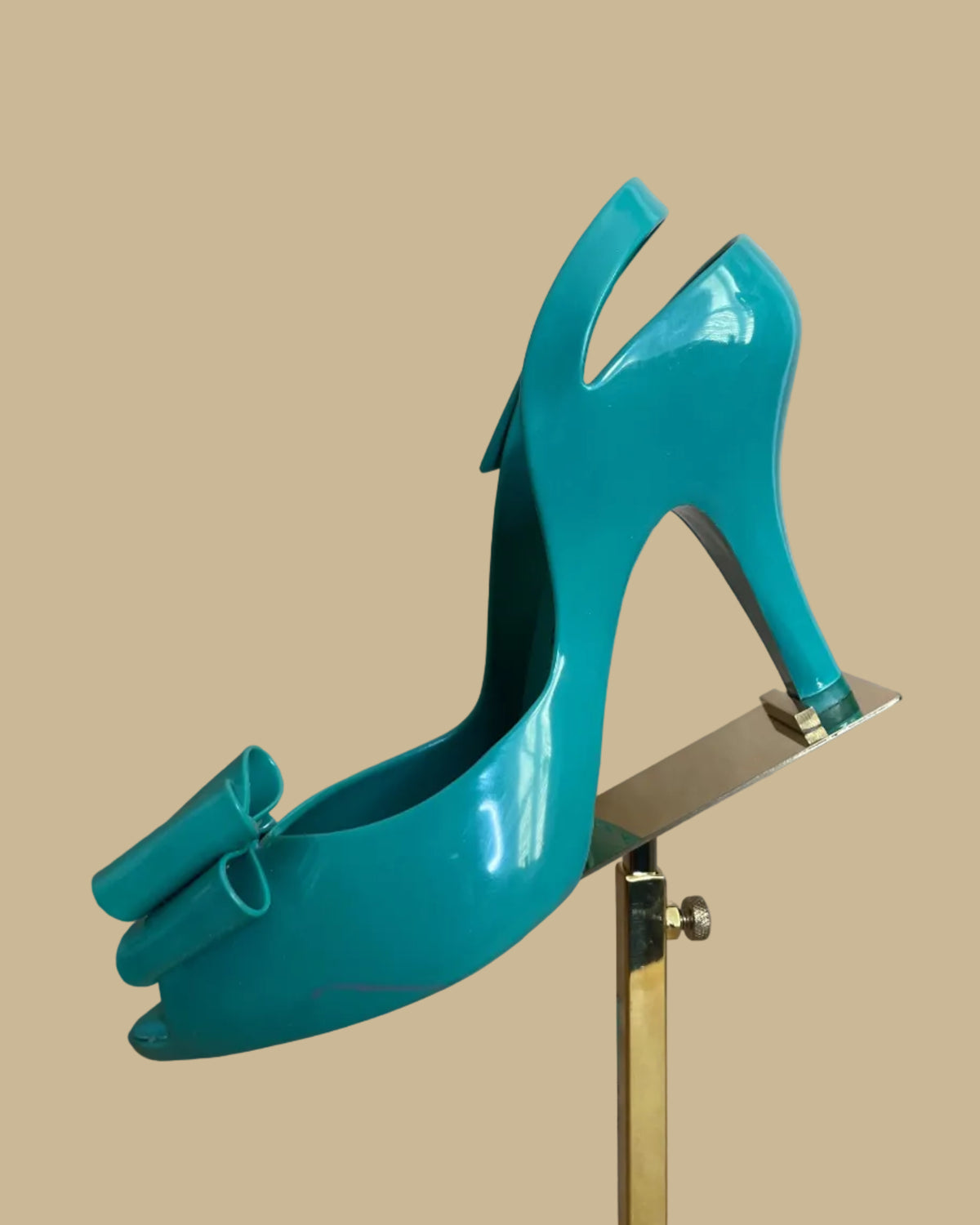 Close-up of the orb-embossed insole on the teal jelly heels
