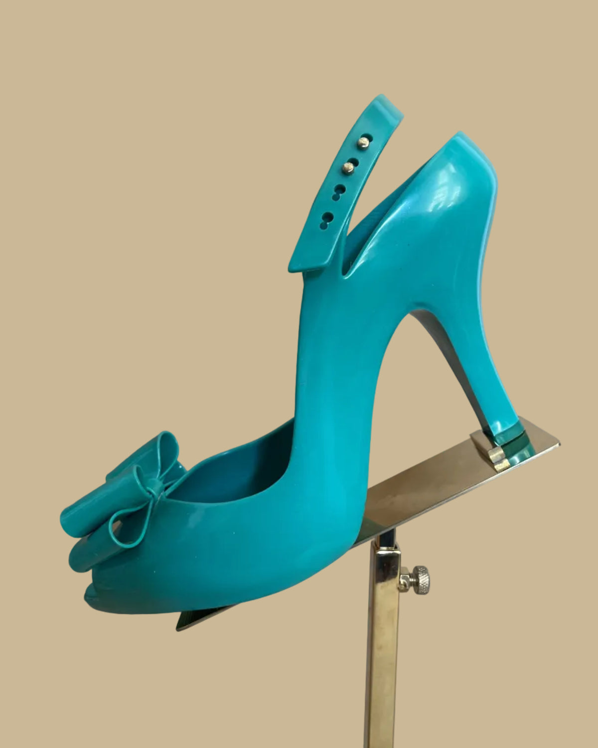 Sole view of the teal jelly bow heels showing size and brand markings