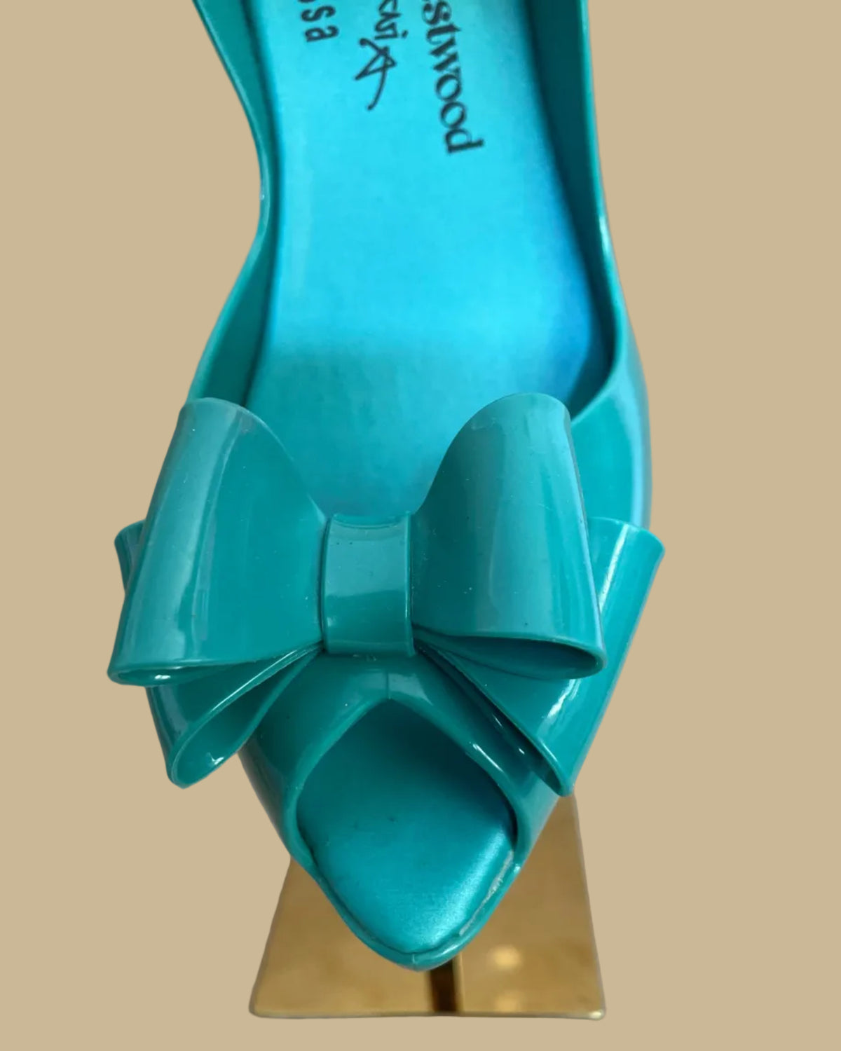 Close-up of the peep toe and bow detail on the teal jelly heels