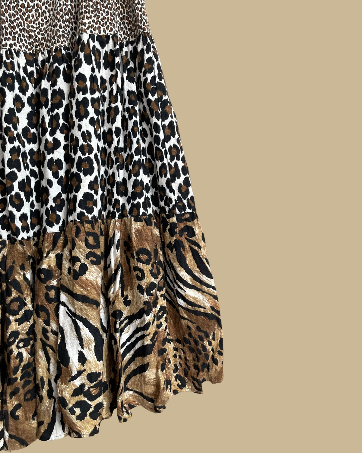 Close-up of the tiered maxi skirt showing the leopard, tiger, and zebra print panels and heavyweight fabric texture