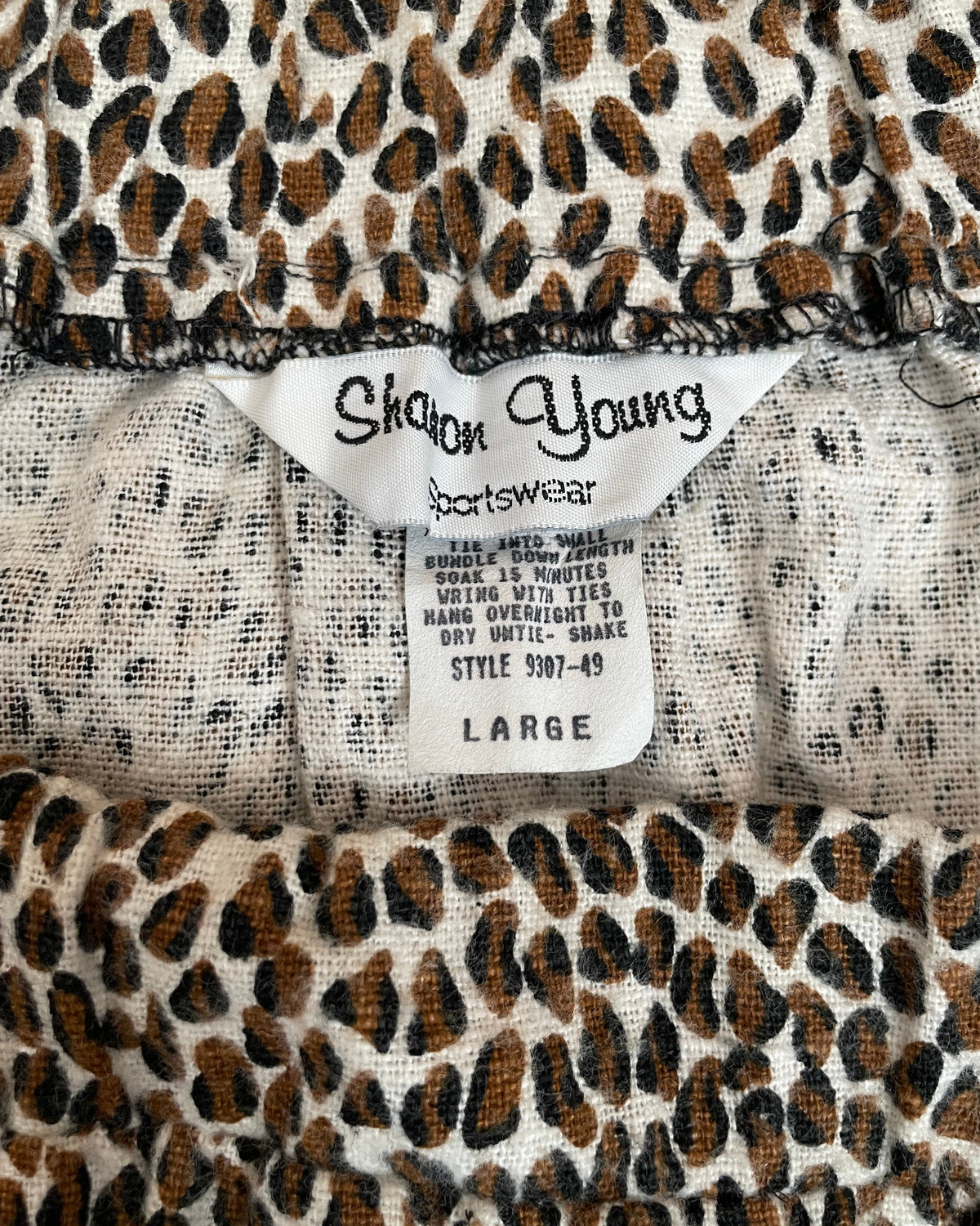 Interior tag of the tiered maxi skirt showing the Sharon Young Sportswear label, size Large, and care instructions