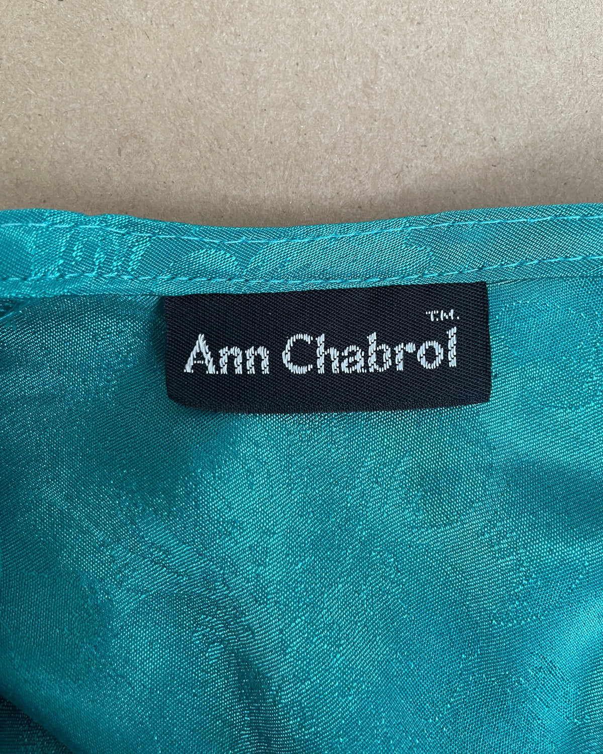 Back view of the teal floral jacquard blouse showing the keyhole closure and silhouette