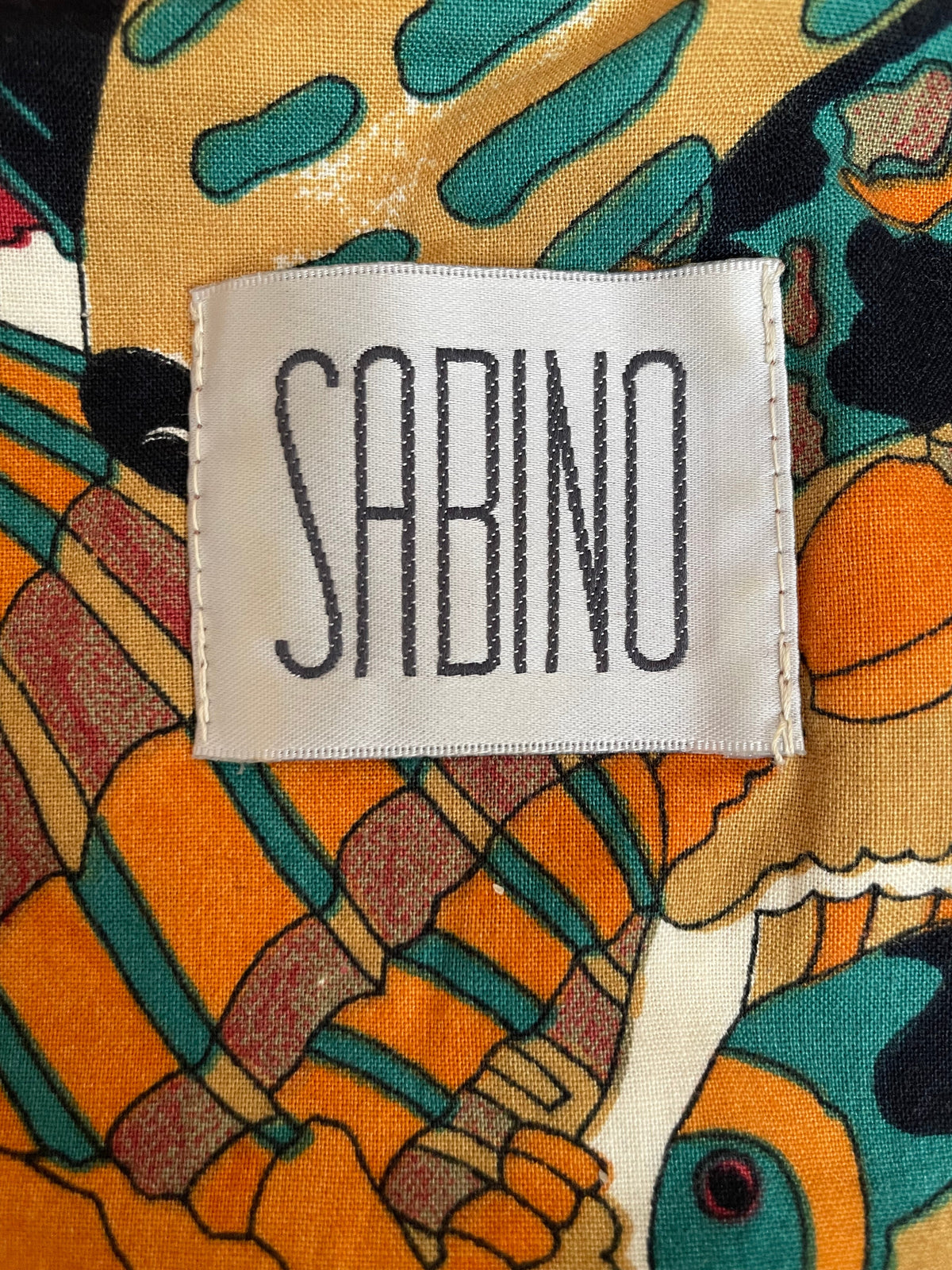 Care label inside the shirtdress showing fabric content, size, and washing instructions