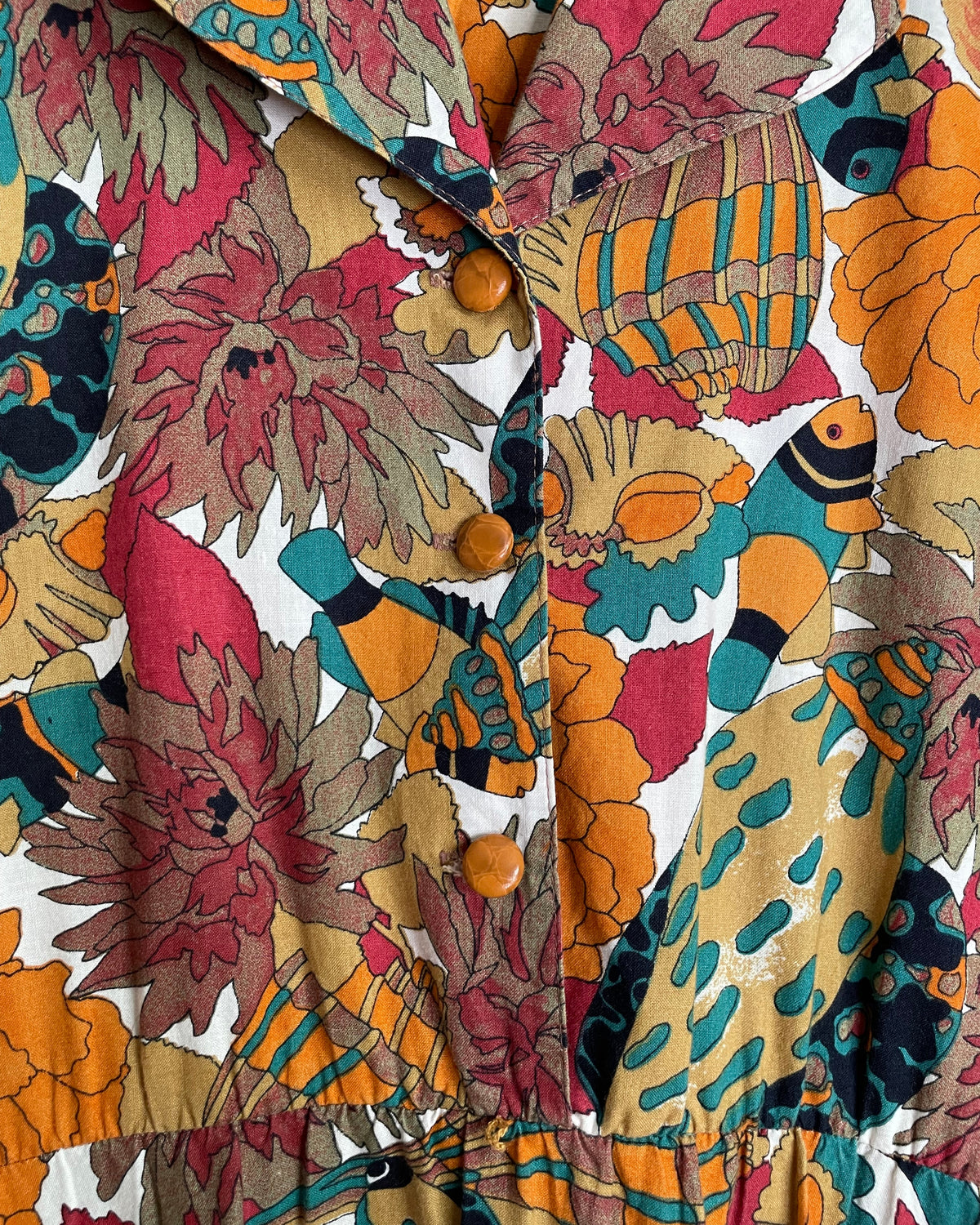 Close-up of the shirtdress pocket detail on the tropical fish and floral print skirt