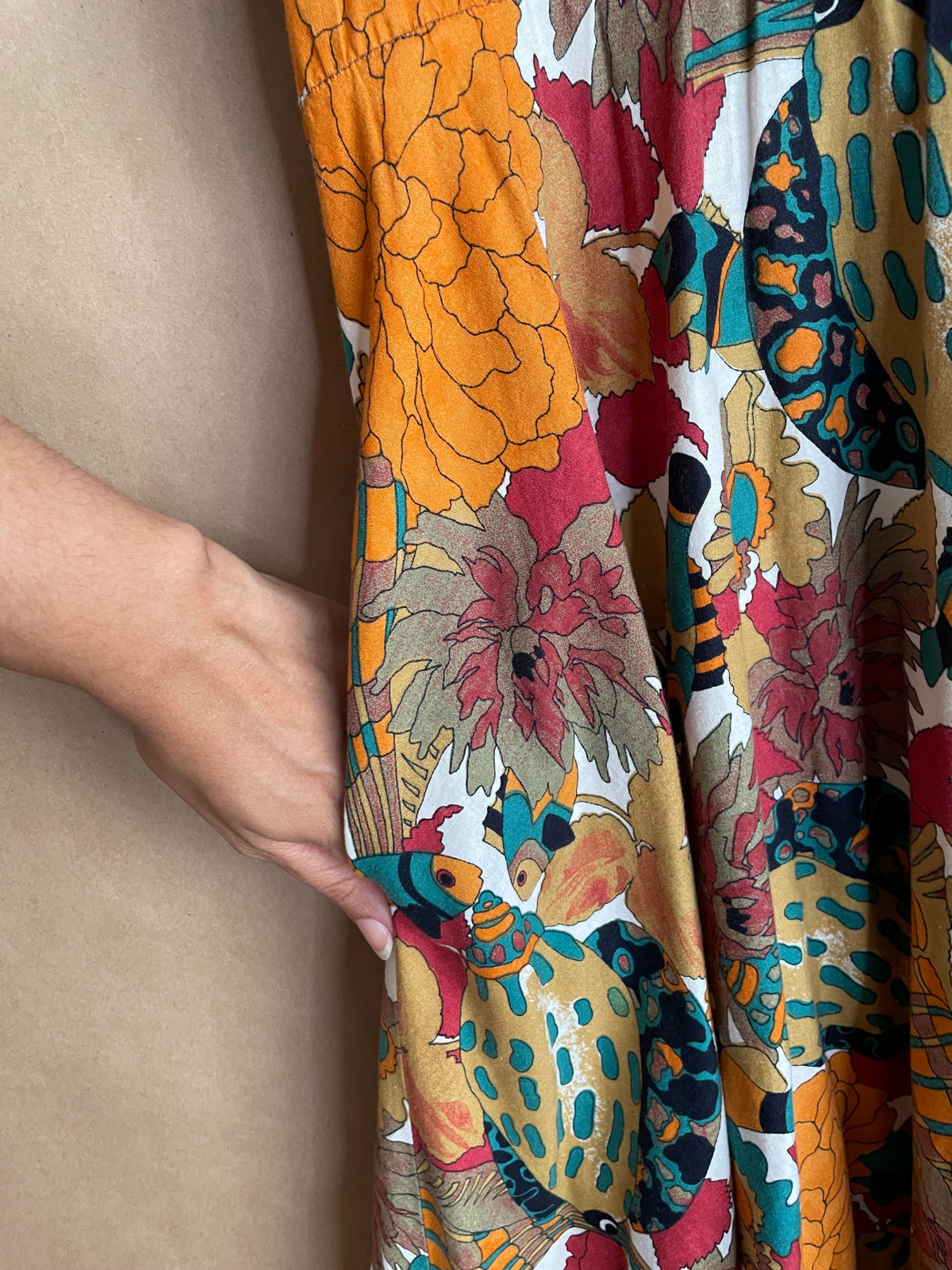Side view of the shirtdress showing the elastic waist and flowing skirt silhouette