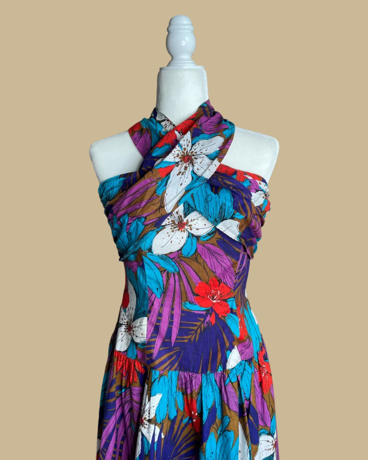 Close-up of the criss-cross halter neckline on the tropical floral dress