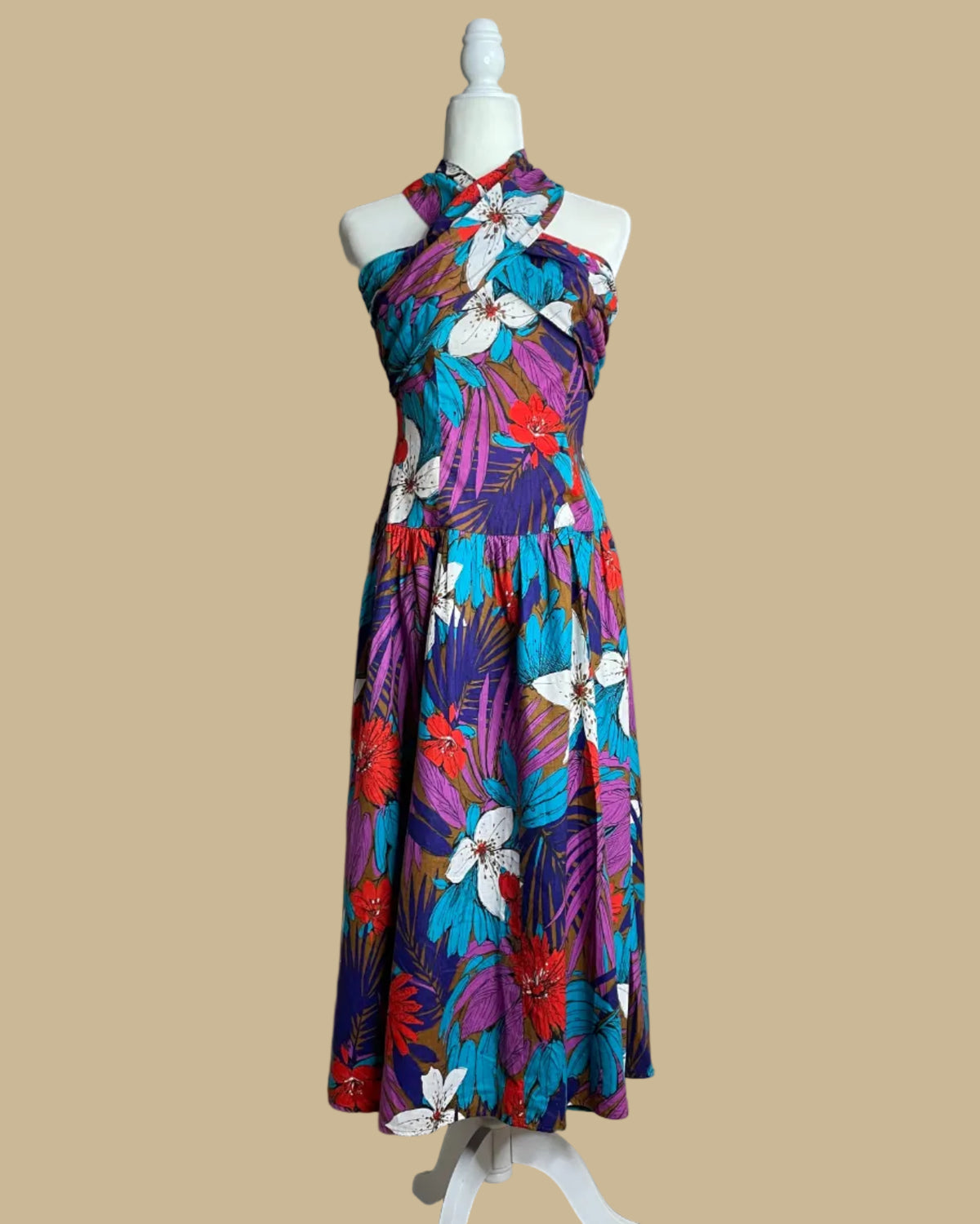 Vintage Robbie Bee tropical floral criss-cross halter dress on a mannequin against a beige background