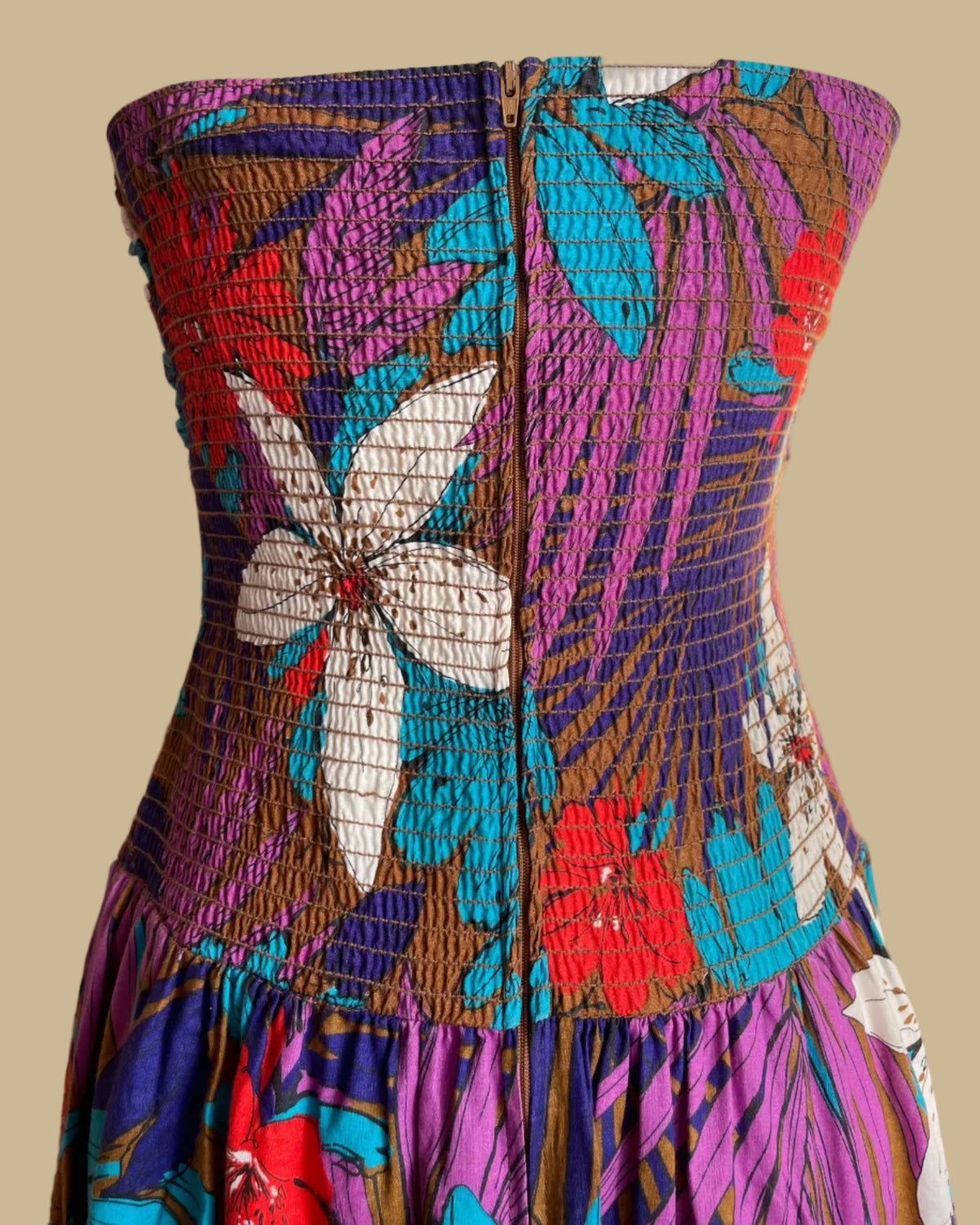 Back view of the tropical floral criss-cross halter dress showing the button closure
