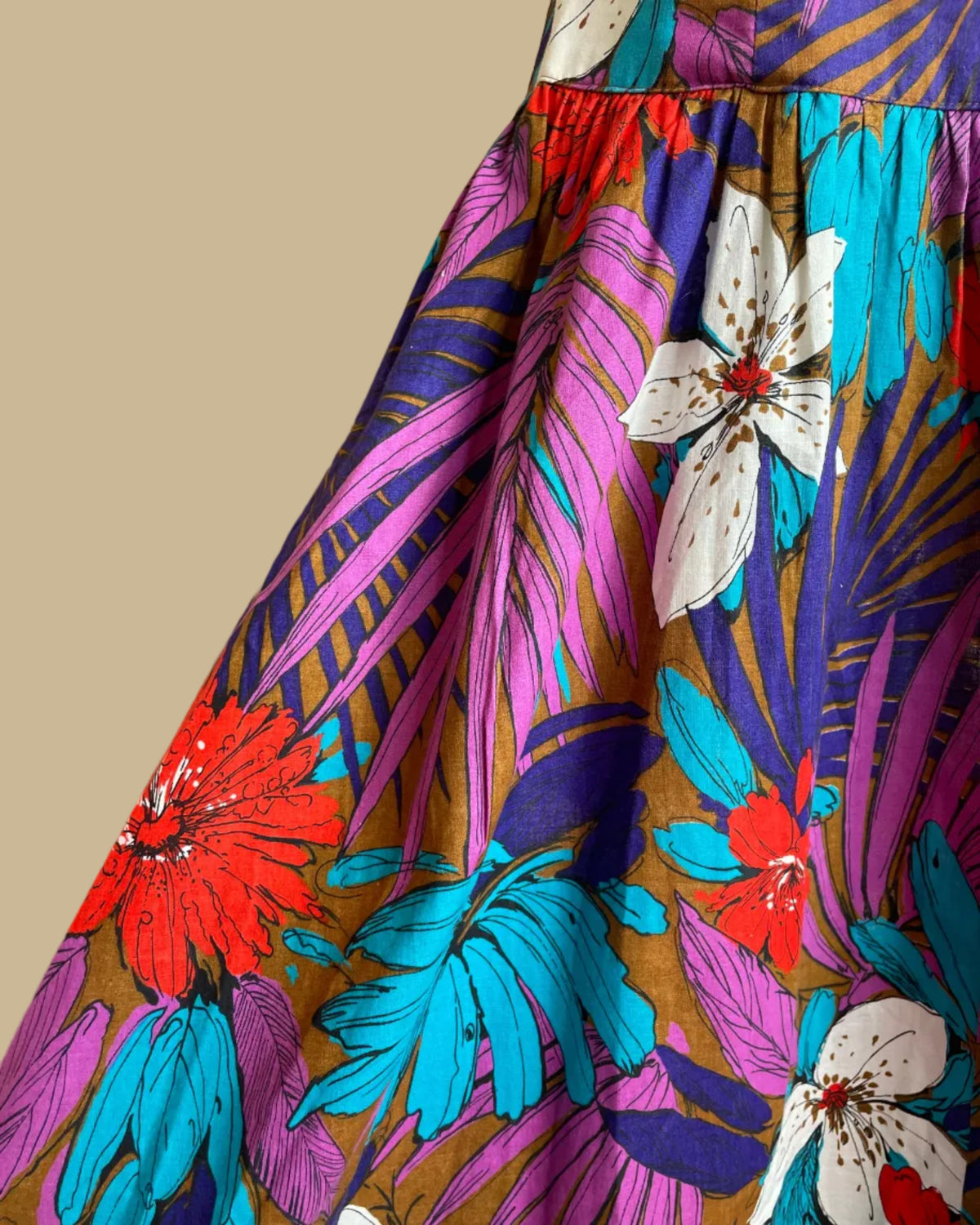 Side view of the tropical floral criss-cross halter dress on a mannequin