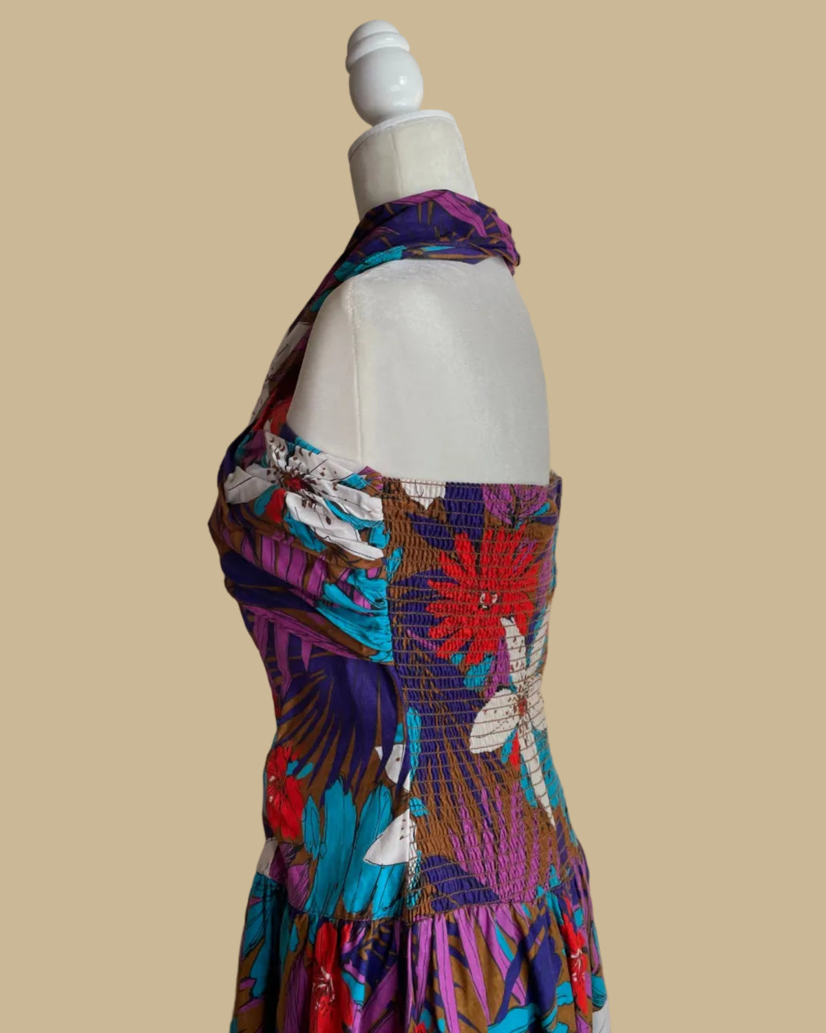 Close-up of the back button closure on the criss-cross halter dress