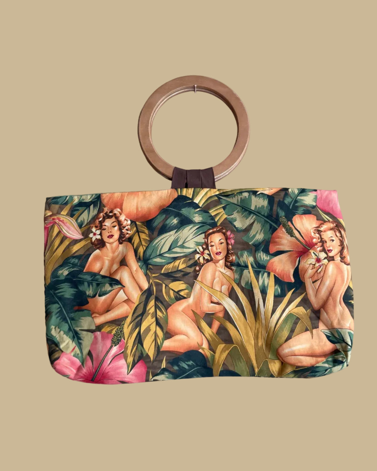 Reversible handmade tote bag with wooden ring handles, showing the tropical pin-up novelty print side against a beige background