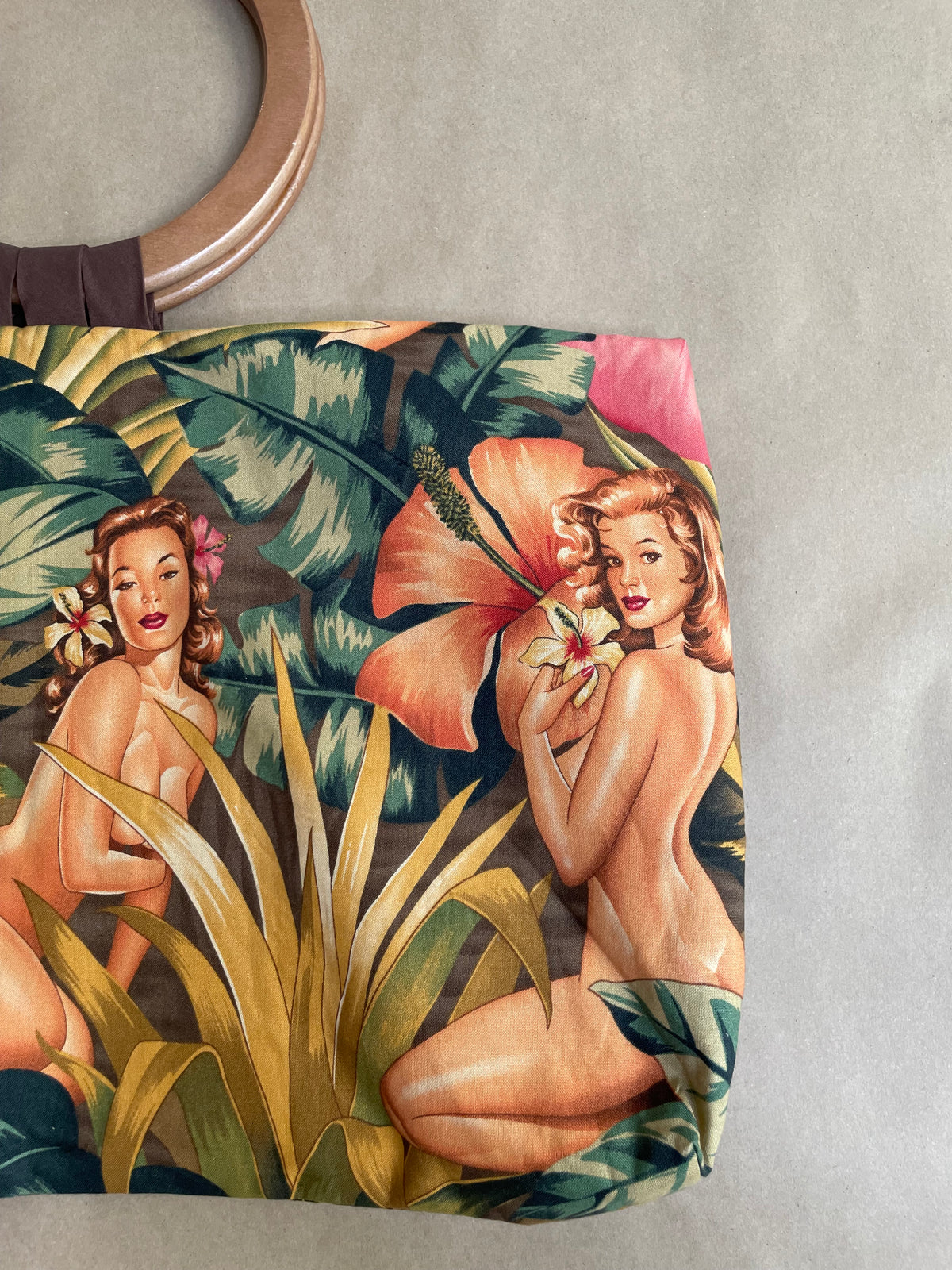 Close-up of the wooden handle attachment detail on the reversible tote