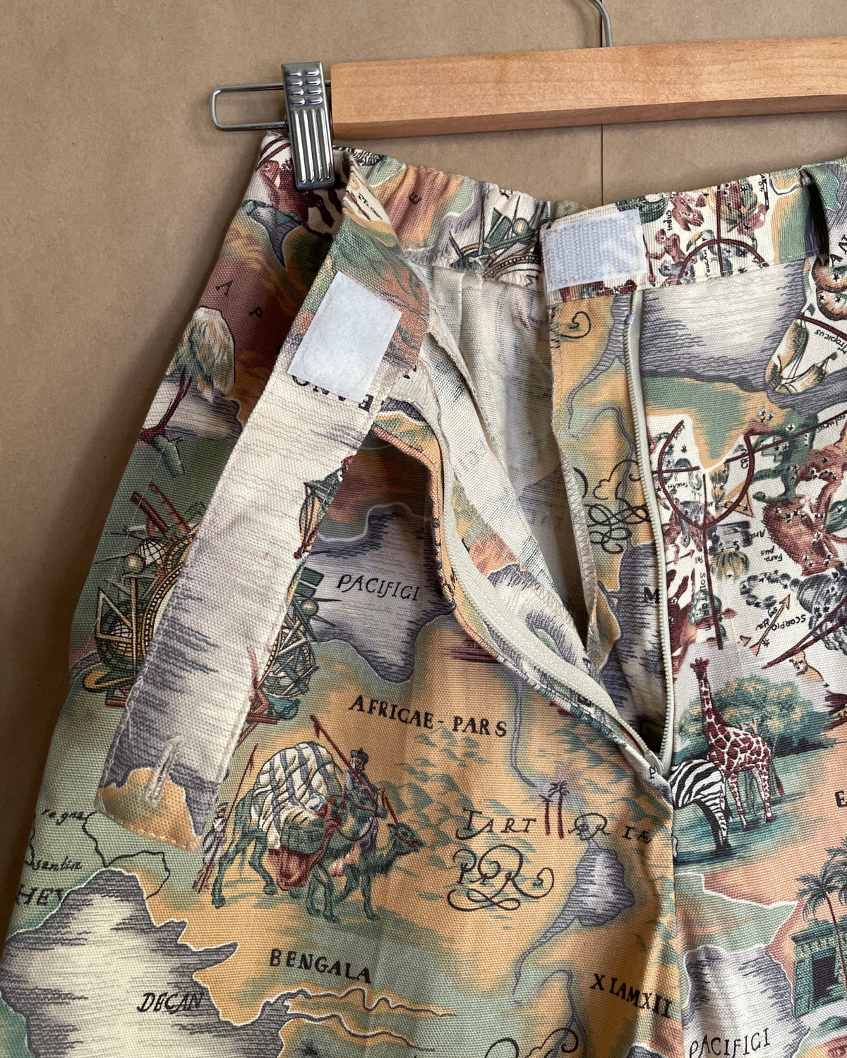 Back view of the vintage map cartography print high-waisted shorts on a hanger