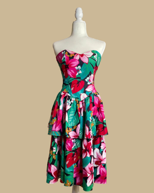 Vintage Robbie Bee tropical floral strapless dress with tiered ruffled skirt on a mannequin against a beige background