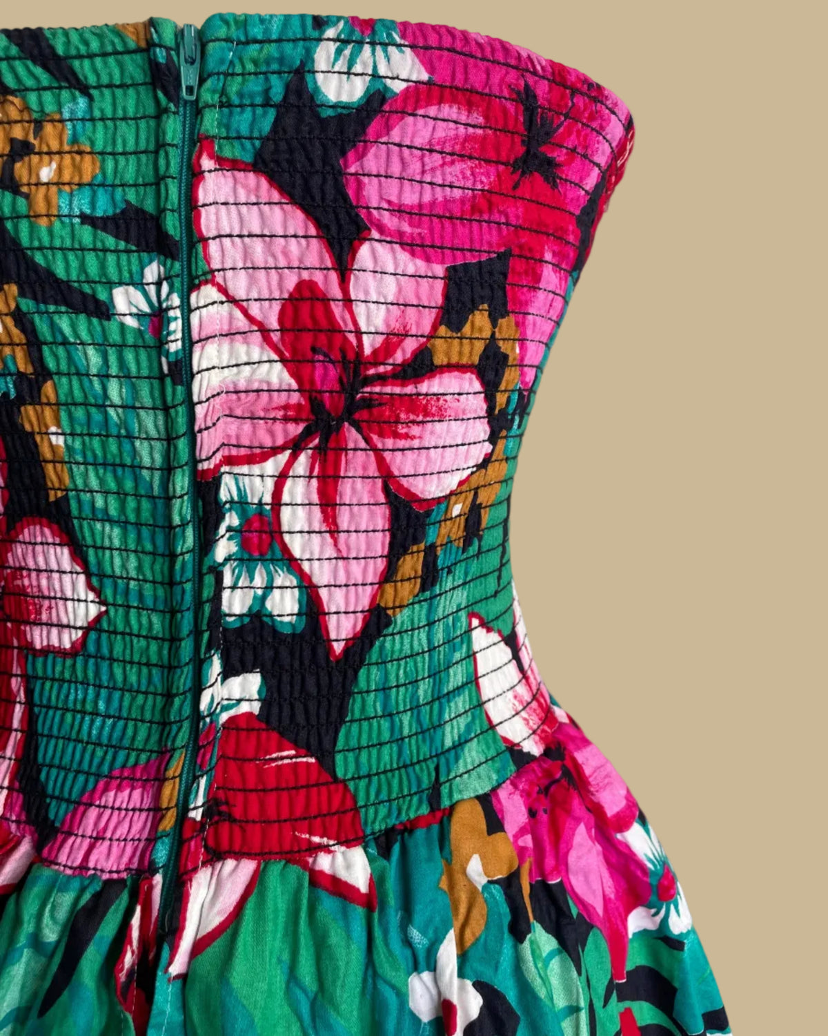 Side view of the tropical floral strapless tiered ruffle dress on a mannequin