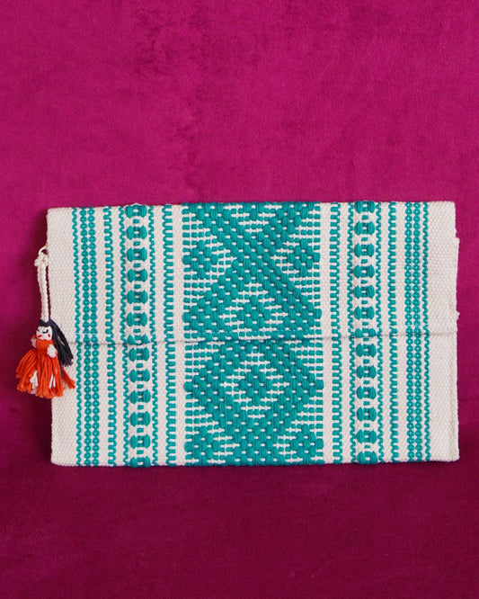 Handwoven cotton clutch in cream and teal with a raised diamond and dot pattern, sourced from Mexico City