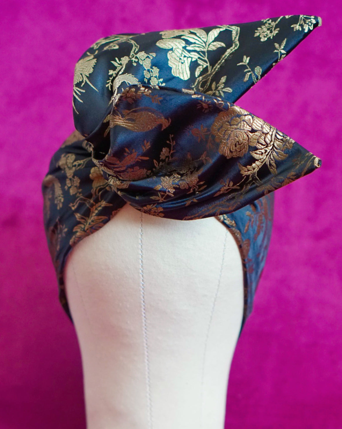 Handmade wired turban headband in black and gold satin brocade woven with perched birds