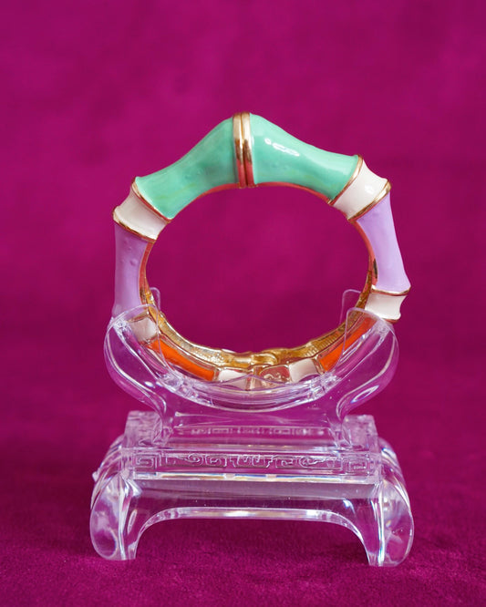 Hinged bangle sculpted like bamboo segments, each enameled in a different pastel color