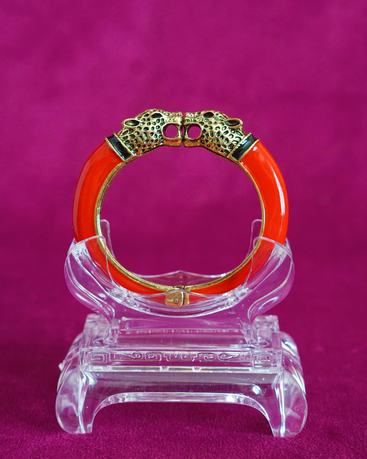 Glossy red enamel hinged bangle capped with two antiqued gold-tone leopard heads
